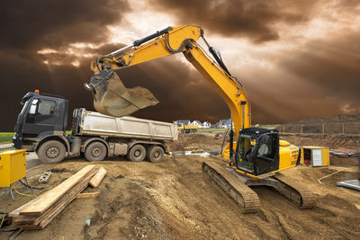 Construction site by road against sky