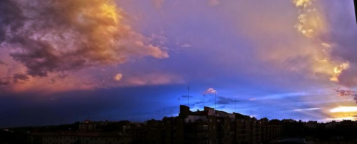 Low angle view of buildings against cloudy sky