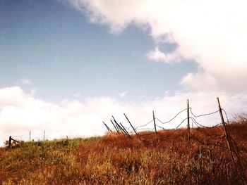 Scenic view of field against cloudy sky