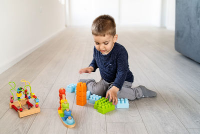 Boy playing with toy at home