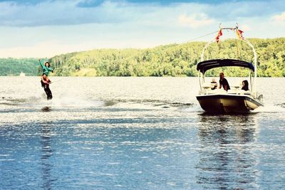 Man in boat on lake against sky