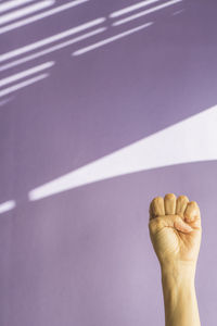 Cropped hand of women against wall