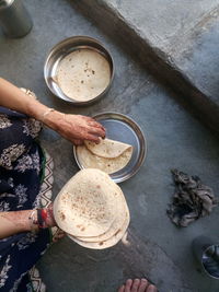 Cropped image of woman holding chapattis