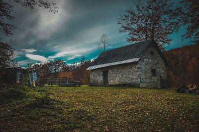 View of old building in field against sky