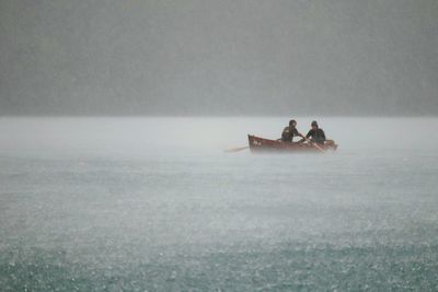 People sitting on boat in sea