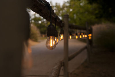 Close-up of illuminated lighting equipment on street