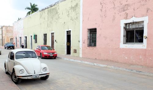 Cars on road by building