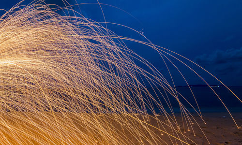 Close-up of fireworks against blue sky