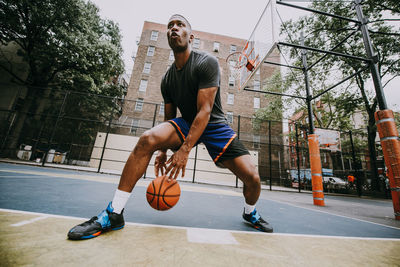 Full length of man playing basketball