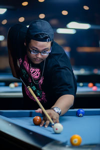 Portrait of woman playing pool