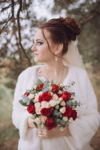 Close-up of woman holding flower bouquet