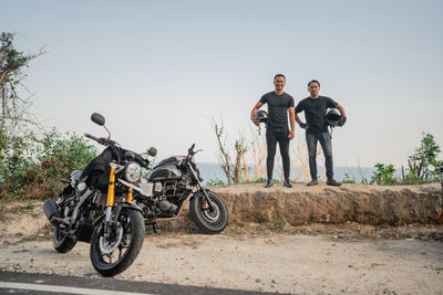 Rear view of man riding motorcycle on road