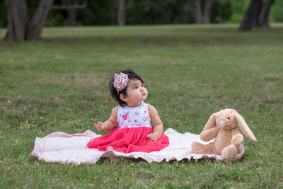 Cute girl sitting on field