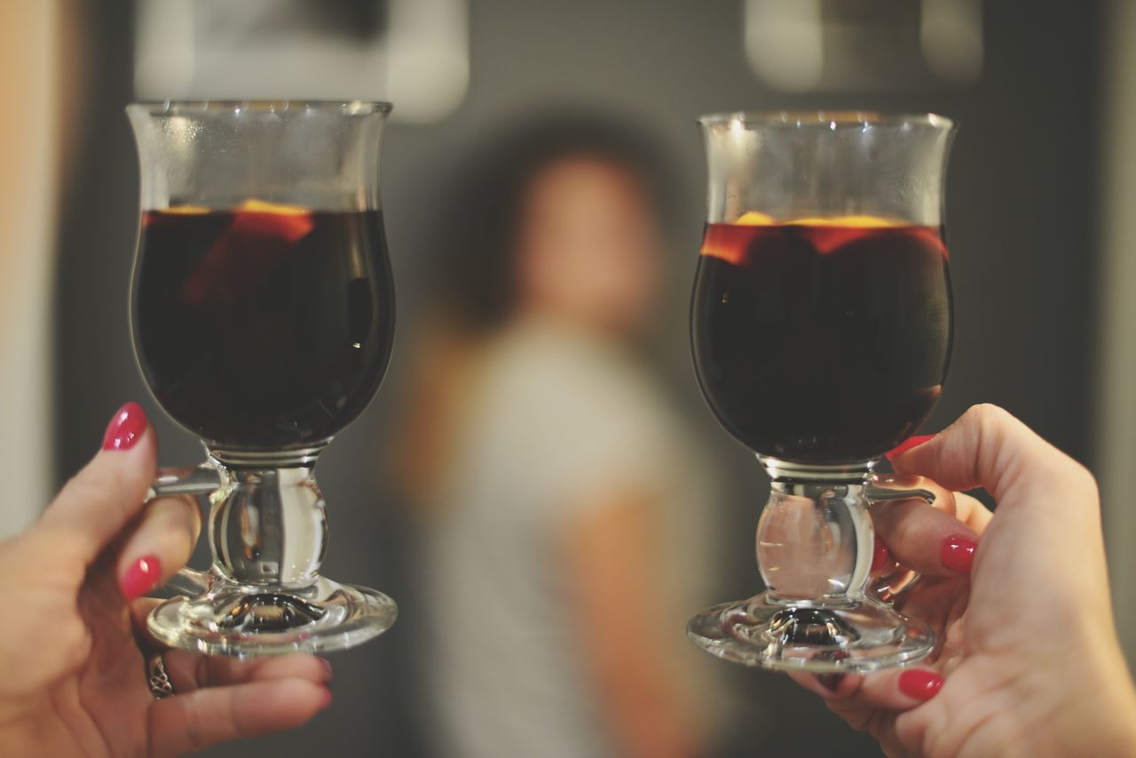wineglass, human hand, wine, holding, alcohol, drink, food and drink, human body part, refreshment, red wine, lifestyles, real people, celebratory toast, indoors, two people, close-up, togetherness, people, freshness, winetasting, happy hour, adult, adults only, day