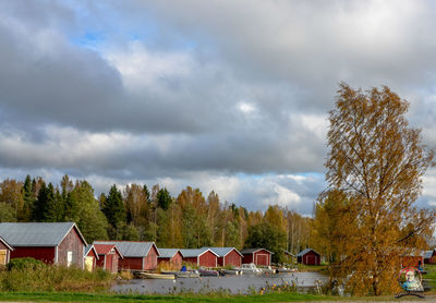 Houses and trees against sky