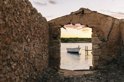 View of old wall by sea against sky