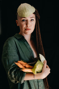 Creative portrait of vegan woman holding vegetables. veganism, vegetarianism, plant-based diet