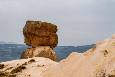 Rock formation on mountain against sky