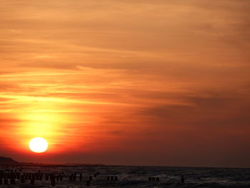 Scenic view of sea against romantic sky at sunset