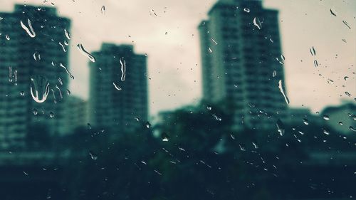 Close-up of wet glass window during rainy season