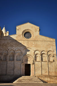 Low angle view of historical building against clear blue sky