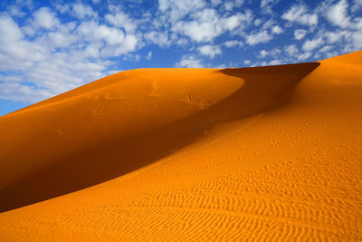 Sand dune against sky