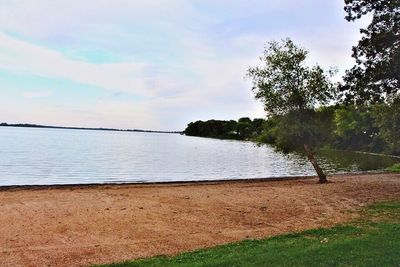 Scenic view of lake against cloudy sky