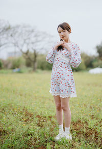 Portrait of boy standing on field