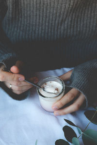 Midsection of man holding coffee cup