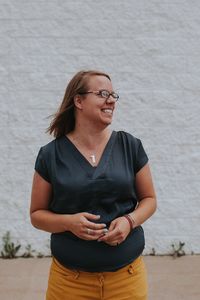 Portrait of smiling young woman standing outdoors