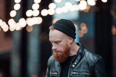 Portrait of young man looking away outdoors