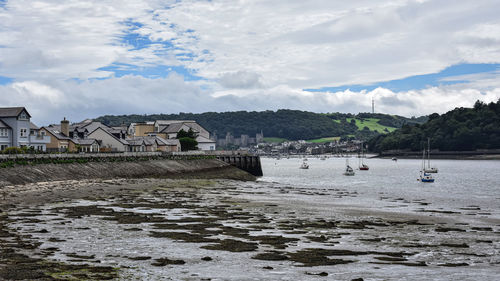 Scenic view of beach and buildings against sky