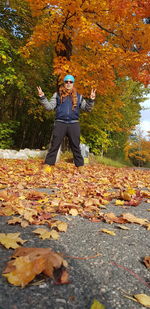 Man standing by leaves during autumn