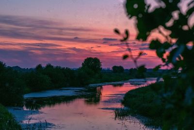Scenic view of lake against orange sky
