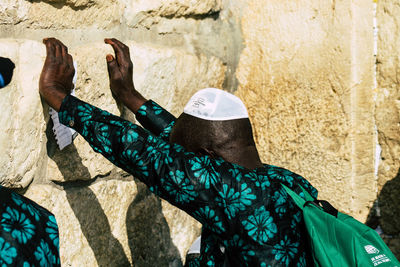 Low section of man standing on rock