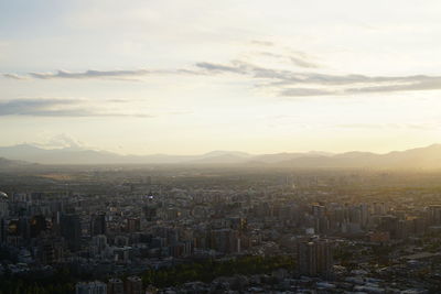 High angle view of cityscape against cloudy sky