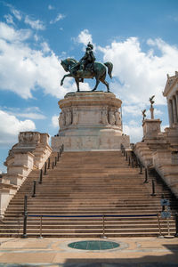 Low angle view of statue against cloudy sky