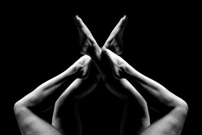 Close-up of woman hand against black background