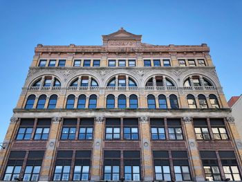 Low angle view of building against blue sky