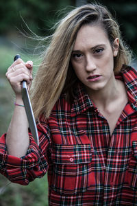 Portrait of young woman holding knife