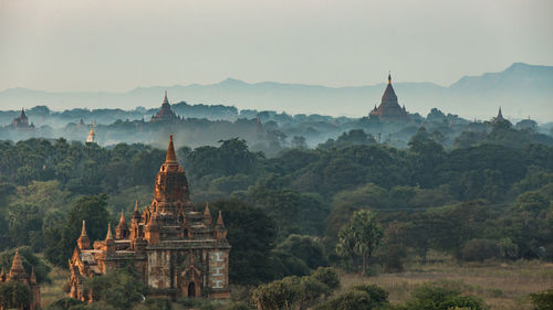 Panoramic view of temple and building against sky