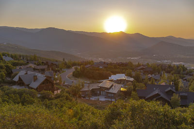 Scenic view of townscape against sky during sunset