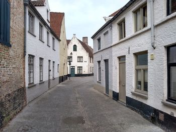 Empty alley amidst buildings in city