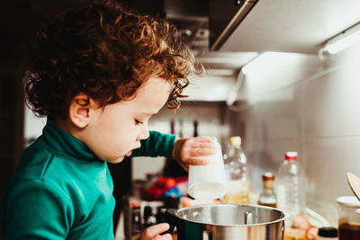 Boy holding ice cream at home