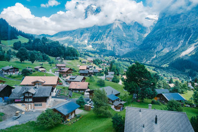 Aerial view of townscape and mountains against sky