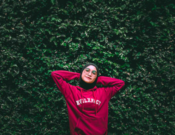 Portrait of smiling young woman standing outdoors