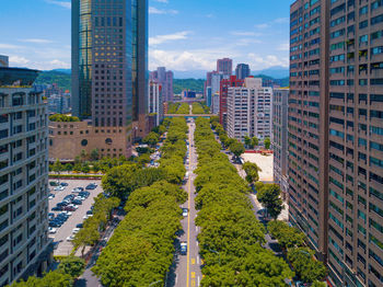 Aerial view of buildings in city against sky