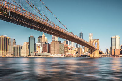 Bridge over river with buildings in background