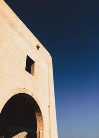 Low angle view of historical building against clear blue sky