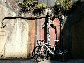 Bicycle parked by wall